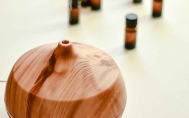Wooden diffuser with aroma oil bottles.