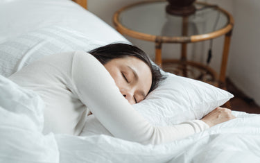 Woman sleeping in bed.