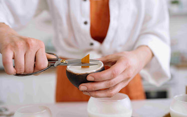 Person cutting candle wick.