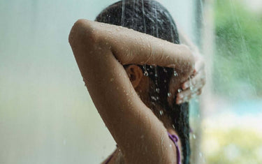 Woman taking a shower and washing hair