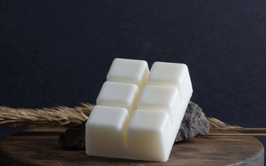 White wax melts on wooden table.
