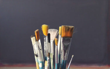Assorted colour of paintbrushes in a paintbrush holder.