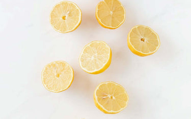 Eight sliced lemons on a white background.