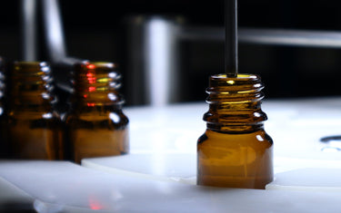 Close up of an amber glass bottle being filled