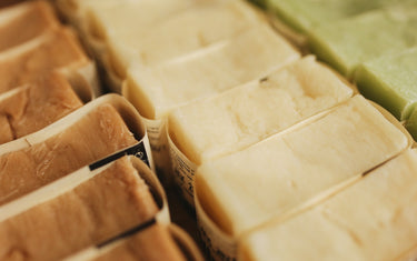 Rows of home made soap bars with wrappers around them ready to sell