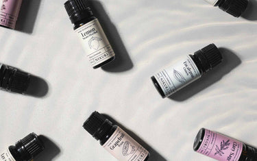 Essential oil bottles in a row on a wooden table