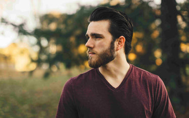 Man with beard in a field.