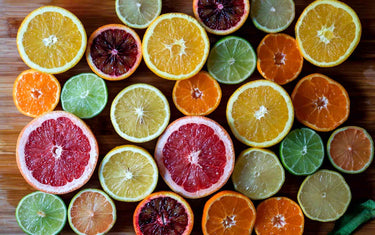 Assortment of slices of citrus fruits including limes, grapefruit, orange and lemon