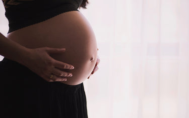 A woman holding her pregnant belly