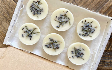 Circular soy wax melts with dried lavender sprinkled on the tops