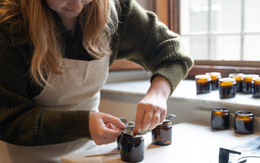 Woman crafting candles at home.