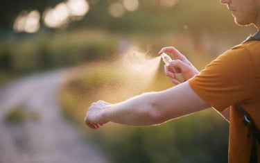 Person spraying onto their arm