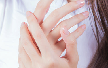 Woman showing manicured nails.