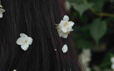 Woman with jasmine flowers in her hair. 