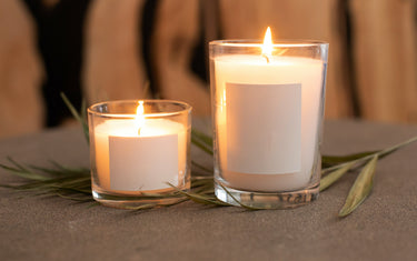 Two lit candles of different sizes. 