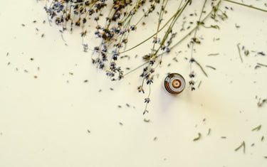 Birds eye view of an amber glass bottle with dried lavender scattered around it