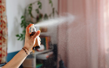 Small spray bottle misting a room