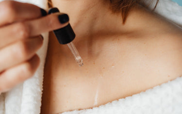 Woman applying oils to her neckline