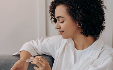 Woman applying a roll on onto her wrist