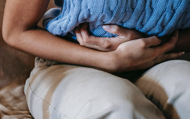 Person clutching abdomen.