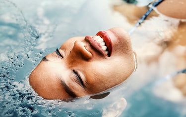 Woman floating in a pool with her head above the water.