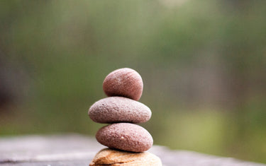 Close up of a pile of four stones balanced one on top of each other
